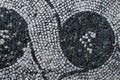 Roman mosaic with small black and white stones tiles representing a decoration. Detail of swirl depicted in a mosaic in Ostia Ant Royalty Free Stock Photo