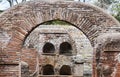 Roman necropolis  columbarium graves in Ostia Antica ruins and view of the arch Royalty Free Stock Photo