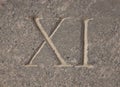 Roman numeral - eleven carved in stone