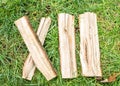 Roman numeral. Roman numerals made from oak. Old wood numbers. Old roman antique alphabet number on green grass background. Number Royalty Free Stock Photo