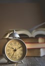 Roman Numeral in Vintage Alarm Clock and Open Book Background wi