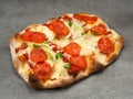 roman pizza with pepperoni on a gray background