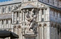 Roman sculpture with small kids and 11th century Pisa Cathedral, Italy. Historic Piazza dei Miracoli, UNESCO Heritage Royalty Free Stock Photo