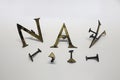 Roman set of letters and punctuation marks made of gilded bronze