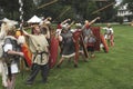 Roman soldiers throw spears at the enemy during a