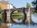 Roman stone bridge located in the Galician city of Monforte de Lemos over the Cabe River Royalty Free Stock Photo