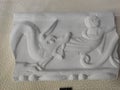 Roman stone decoration relief horned demon devours man