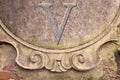 Roman V number written on stucco wall - concept image