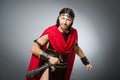 Roman warrior with sword against background Royalty Free Stock Photo