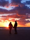 Romance after dark. Silhouette of a couple going for a walk on the beach at sunset. Royalty Free Stock Photo