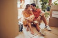 Romance, fun and an intimate moment between a couple moving into a new home. Young lovers being affectionate, flirting Royalty Free Stock Photo