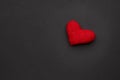 romance and love concept. red heart symbol over black moody background. view from above