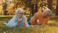 Romance at old age. Elderly couple blowing soap bubbles in the park in autumn Royalty Free Stock Photo