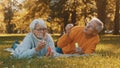 Romance at old age. Elderly couple blowing soap bubbles in the park in autumn Royalty Free Stock Photo
