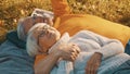 Romance at old age. Retired couple enjoying autumn day in park. Lying on the blanket and looking at each other Royalty Free Stock Photo