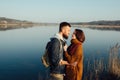 Romance and rest. A loving couple near a blue lake Royalty Free Stock Photo