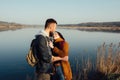 Romance and rest. A loving couple near a blue lake Royalty Free Stock Photo