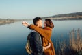 Romance and rest. A loving couple near a blue lake Royalty Free Stock Photo