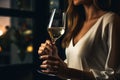 Romance and sexuality. Hand of a young woman with a glass of white wine. Royalty Free Stock Photo
