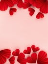 Romance Valentines day background with red paper hearts fly on pastel pink background, top view, header, footer border, copy space Royalty Free Stock Photo