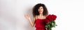 Romance and Valentines day. Woman gasping surprised and happy, receive surprise gift from lover, holding bouquet of red Royalty Free Stock Photo