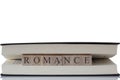 Romance written on wooden blocks inside a book isolated on a white background Royalty Free Stock Photo