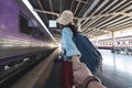 Romance young Asian woman holding boyfriend hands follow her at train station. Romantic and travel in summer vacation concept