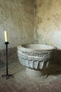Romanesce baptismal font whit candle in Calatanazor, Soria. Royalty Free Stock Photo