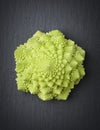 Romanesco broccoli on a stone slab.