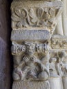 Romanesque capital of lions eating a man in the church of Santa Maria of Baldos, Montanana, Huesca, Spain