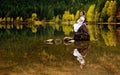 Romania beautiful girl on Saint Ana volcanic lake with traditional costume Royalty Free Stock Photo