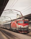 Romania, Bucharest. March 20, 2022 Express to Vienna. High speed red suburban train at the railway station. Train on the railway p