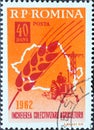 Romania - Circa 1962: a postage stamp printed in the Romania showing an Ear of corn, map of Romania and tractor and power line