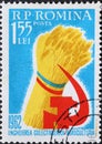 Romania - Circa 1962: a postage stamp printed in the Romania showing a Wheatsheat and hammer and sickle emblem