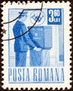 ROMANIA - CIRCA 1971: A stamp printed in Romania shows a postman collecting the mail, circa 1971. Royalty Free Stock Photo