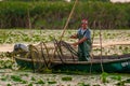 ROMANIA, DANUBE DELTA, AUGUST 2019: Fisherman catching a fish from the net in the Danube Delta Royalty Free Stock Photo