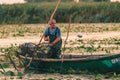 ROMANIA, DANUBE DELTA, AUGUST 2019: Fisherman throwing the small fish back into the water Royalty Free Stock Photo