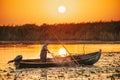 ROMANIA, DANUBE DELTA, AUGUST 2019: Sunrise in the Danube Delta. Fisherman checking the nets overnight catch Royalty Free Stock Photo