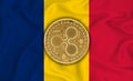 Romania flag, ripple gold coin on flag background. The concept of blockchain, bitcoin, currency decentralization in the country.