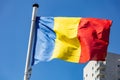 Romania flag waving against clear blue sky Royalty Free Stock Photo