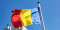 Romania flag waving against clear blue sky Royalty Free Stock Photo