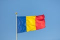 Romania flag waving against clean blue sky, close up Royalty Free Stock Photo