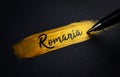 Romania Handwriting Text on Golden Paint Brush Stroke Royalty Free Stock Photo