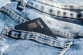 Romania -May 17,,2020 : Paxum plastic card in the back pocket of jeans . Concept of savings, during the financial crisis or card