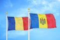 Romania and Moldova two flags on flagpoles and blue sky