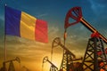 Romania oil industry concept. Industrial illustration - Romania flag and oil wells against the blue and yellow sunset sky Royalty Free Stock Photo