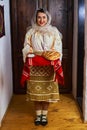 Romania in an old traditional bride costume offering bread and salt