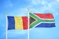 Romania and South Africa two flags on flagpoles and blue sky