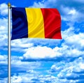 Romania waving flag against blue sky Royalty Free Stock Photo