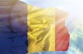 Romania waving flag against blue sky with sunrays Royalty Free Stock Photo